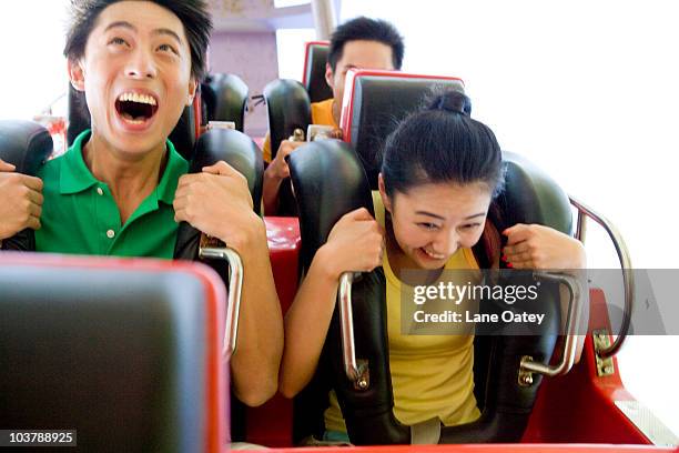 young people riding a rollercoaster - man on rollercoaster stock pictures, royalty-free photos & images