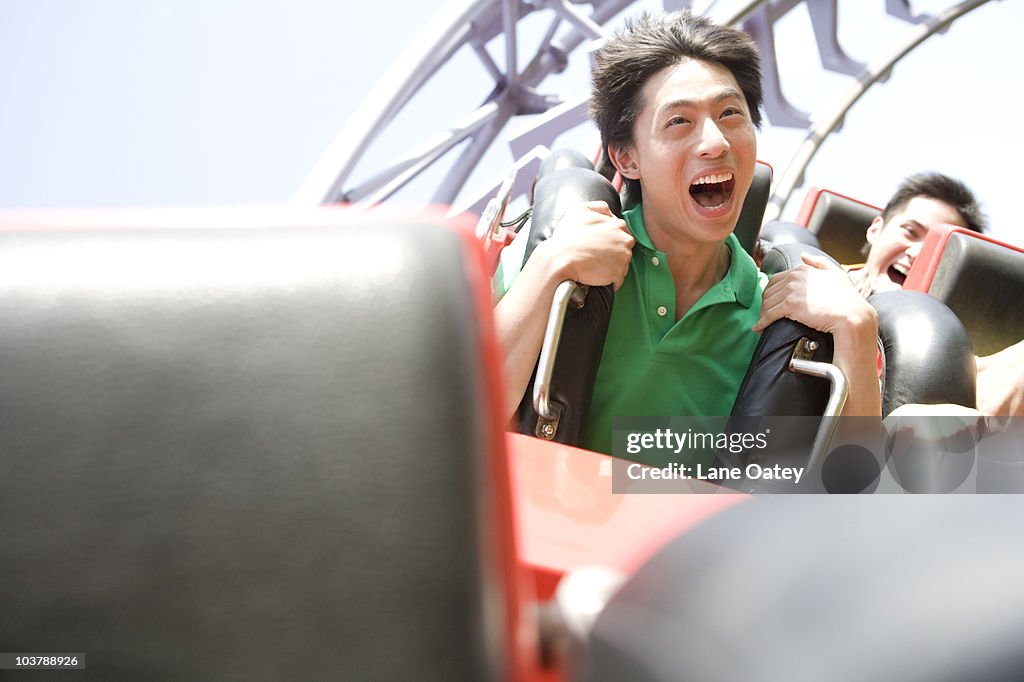 Young people riding a rollercoaster