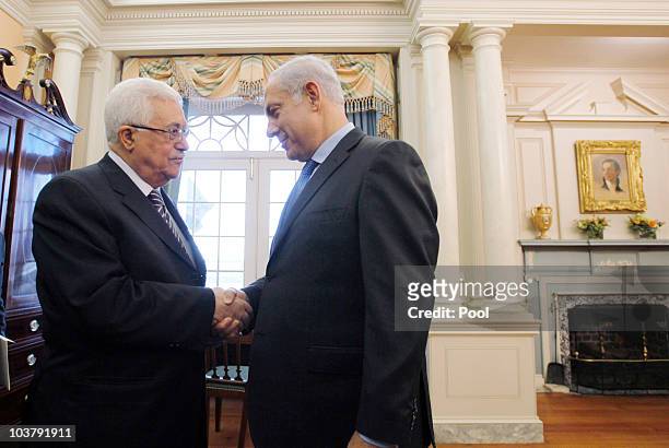 President of the Palestinian Authority Mahmoud Abbas shakes hands with Israeli Prime Minister Benjamin before holding direct peace talks at the State...