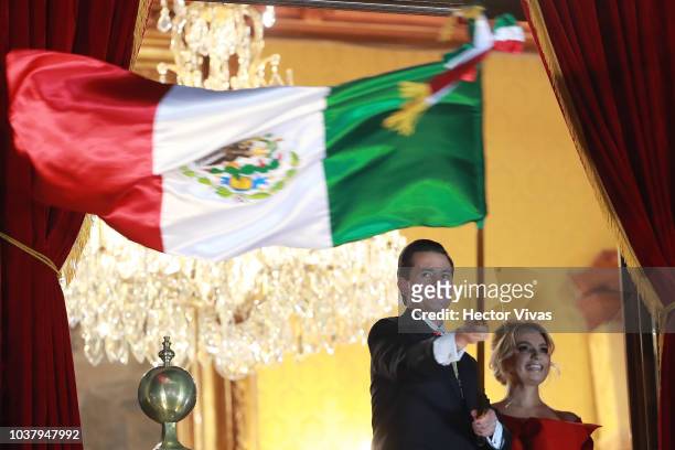 Enrique Peña Nieto, President of Mexico waves a Mexican flag during the Mexico Independence Day Celebrations at Zocalo on September 15, 2018 in...