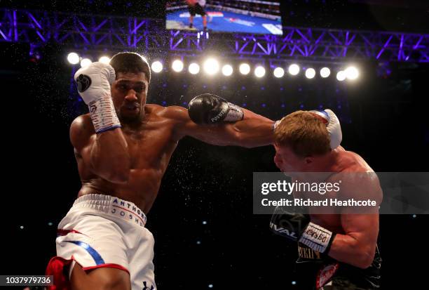 Anthony Joshua and Alexander Povetkin exchange punches during the IBF, WBA Super, WBO & IBO World Heavyweight Championship title fight between...