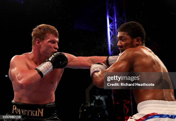 Alexander Povetkin punches Anthony Joshua during the IBF, WBA Super, WBO & IBO World Heavyweight Championship title fight between Anthony Joshua and...