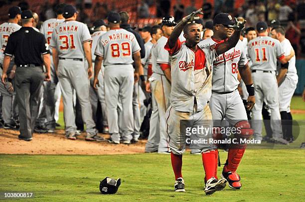 Nyjer Morgan of the Washington Nationals gestures to the crowd as he walks off the field after a brawl during an MLB game against the Florida Marlins...
