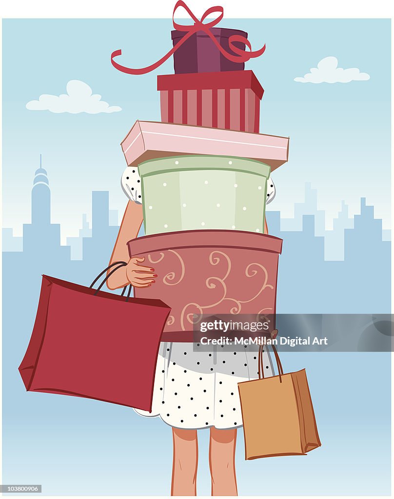 Woman carrying boxes and shopping bags
