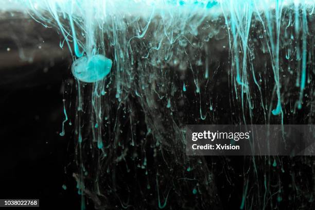 blue and red color mixing in water with black background studio shot - blender explosion stock pictures, royalty-free photos & images