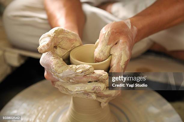 potter making bowl on pottery wheel, close-up - potter's wheel stock pictures, royalty-free photos & images