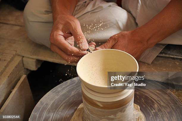 potter making bowl on pottery wheel, close-up - potter's wheel stock pictures, royalty-free photos & images