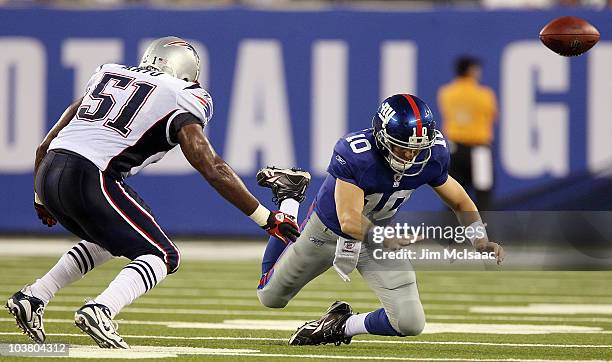 Eli Manning of the New York Giants fumbles the ball in the first quarter as he is pressured by Jerod Mayo of the New England Patriots on September 2,...