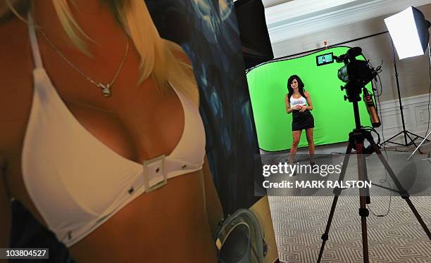 Model Amie Nicole does a video promotion during a Bench Warmer trading cards signing session in West Hollywood on September 2, 2010. Fifty of...