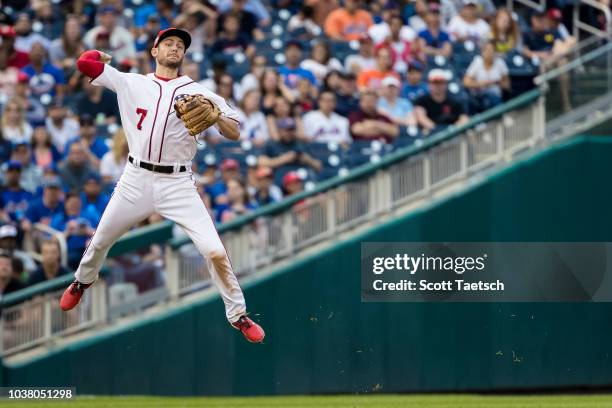 Trea Turner of the Washington Nationals makes a leaping throw to first to retire Kevin Plawecki of the New York Mets during the seventh inning at...