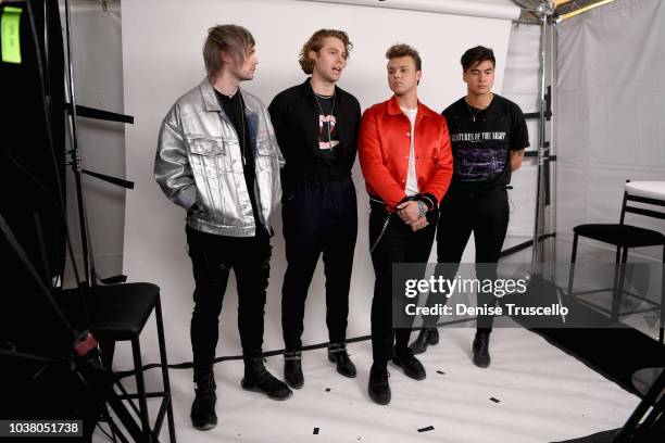 Michael Clifford, Luke Hemmings, Ashton Irwin and Calum Hood of 5 Seconds of Summer pose backstage during the 2018 iHeartRadio Music Festival Daytime...