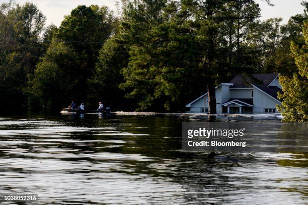 Boat rides through floodwater after Hurricane Florence hit in Bergaw, North Carolina, U.S., on Friday, Sept. 21, 2018. President Donald Trump lauded...