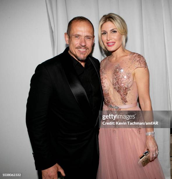 Gery Keszler and Hofit Golan are seen during the cocktail reception of amfAR Gala at La Permanente on September 22, 2018 in Milan, Italy.