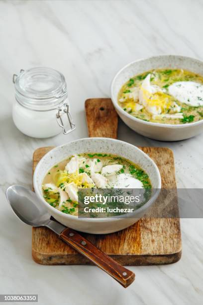 quinoa chicken soup with herby lemon - chicken soup cup stock pictures, royalty-free photos & images