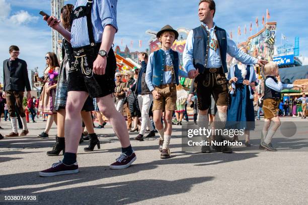 Thousands of visitors rush onto the festival area after the official entrance opening to get the best places on the first day of the 2018 Oktoberfest...