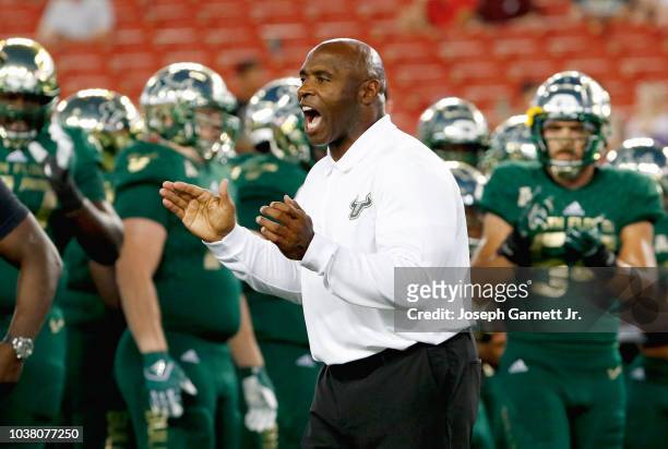Head coach Charlie Strong of South Florida tries to get his team fired up during pregame warmups before the start of the game against East Carolina...