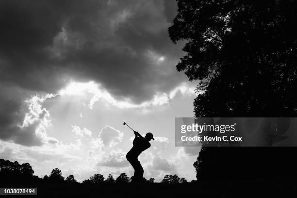 Tiger Woods of the United States plays his shot from the 12th tee during the third round of the TOUR Championship at East Lake Golf Club on September...