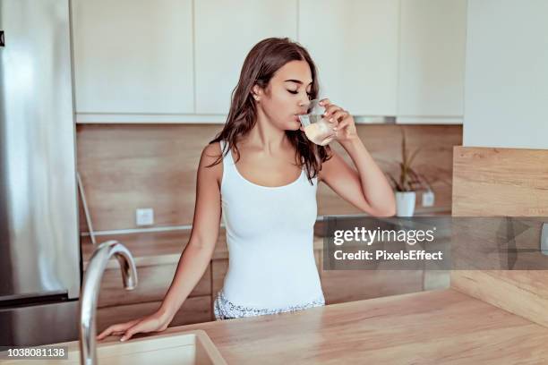 healthy drinking water - woman on plain background stock pictures, royalty-free photos & images