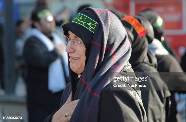 An Iranian woman cries while as an Imam recites the details of the death of the third Imam, Hussein during the holy month of Muharram in Toronto,...