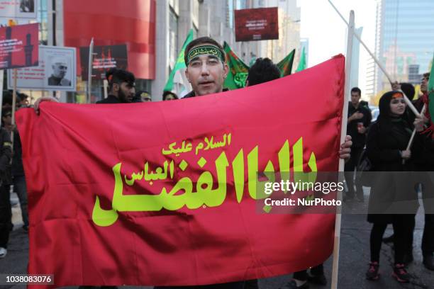 Iranian Shiite Muslim mourners take part in a Muharram procession in Toronto, Ontario, Canada, on October 12, 2016. Hundreds of Shiite Muslims took...