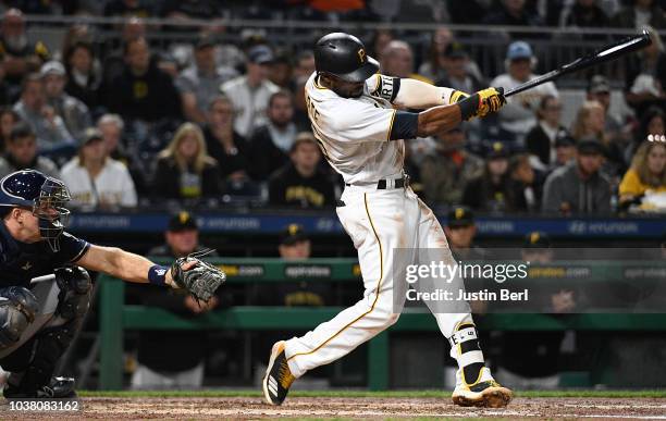 Starling Marte of the Pittsburgh Pirates hits a two run RBI double to left field in the third inning during the game against the Milwaukee Brewers at...