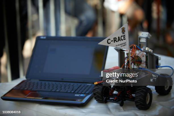 Robot car and a laptop to program it during the race. A robots race took place in Toulouse. Machines are either cars or walking robots. They were...