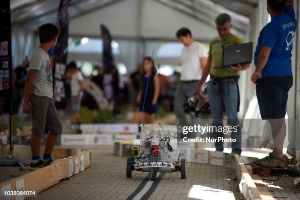 Man verifies how his robot will compete during a try. A robots race took place in Toulouse. Machines are either cars or walking robots. They were...