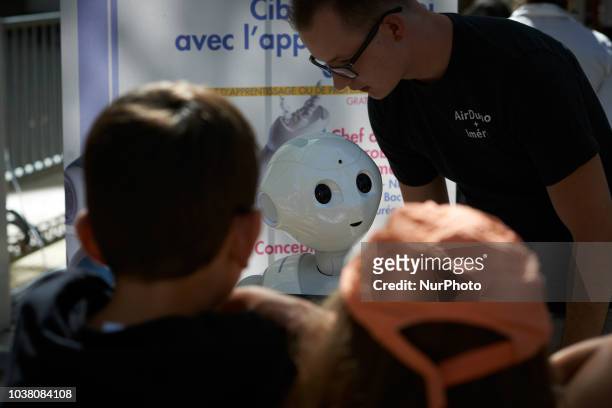SoftBank robot speaks with children. A robots race took place in Toulouse. Machines are either cars or walking robots. They were supposed to run a...