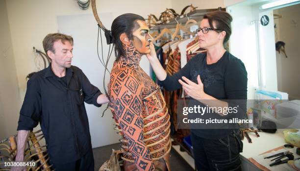 Actor Bernd Lambrecht is dressed for his role as Scar, by chief make-up artist Susanne Berghoff-Huehnerfuss and dresser Ralf Clasen for the Lion King...