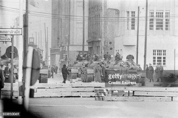 Soviet tanks and troops at Checkpoint Charlie, a crossing point in the Berlin Wall between the American and Soviet sectors of the city at the...