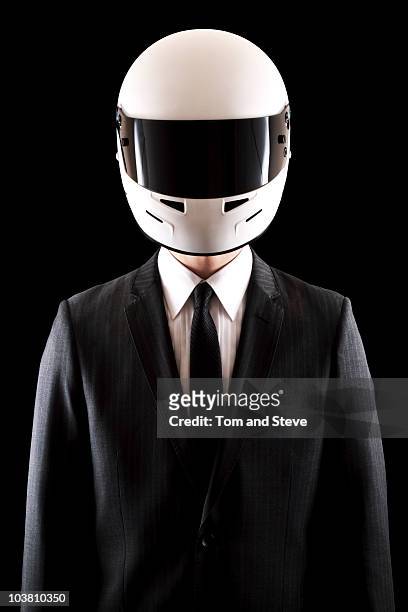 racing driver businessman in pinstripe suit straig - motorradhelm stock-fotos und bilder