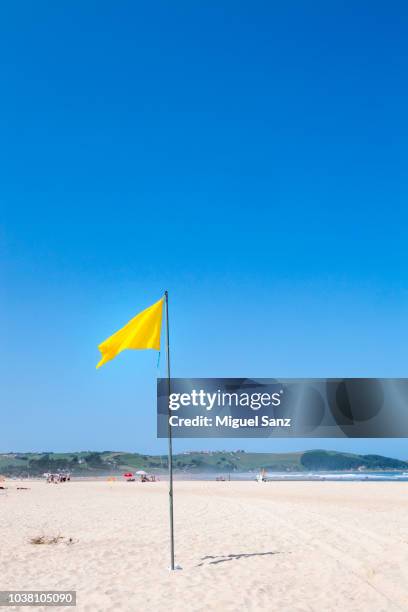 yellow flag at beach - vertical flag stock pictures, royalty-free photos & images