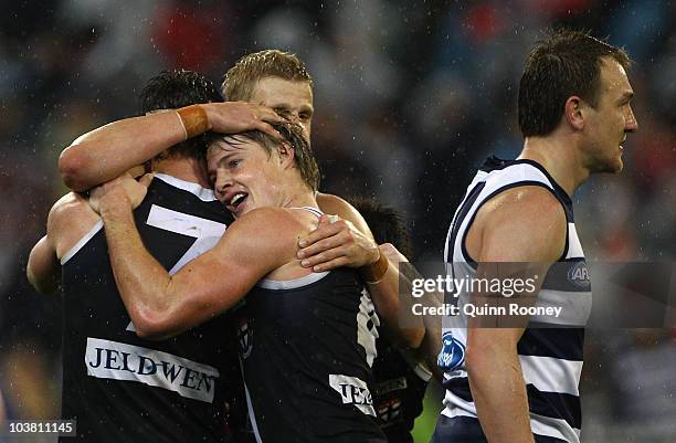 Lenny Hayes, Clinton Jones and Nick Riewoldt of the Saints celebrate as Darren Milburn of the Cats looks dejected after the Saints won the AFL Second...