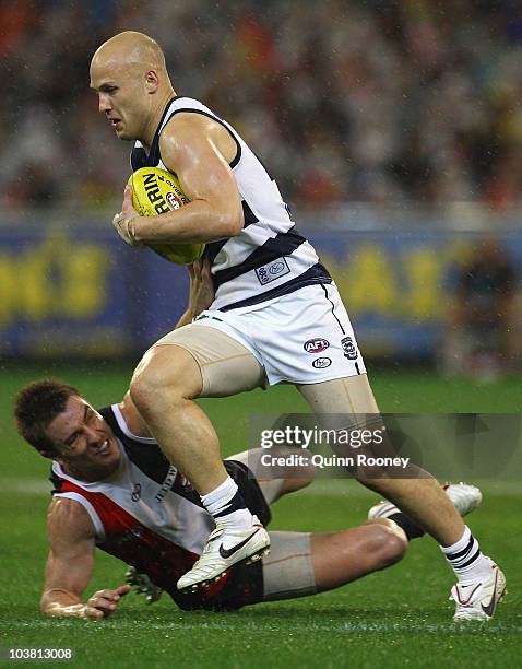 Gary Ablett of the Cats breaks past a tackle by Sam Fisher of the Saints during the AFL Second Qualifying Final match between the Geelong Cats and...