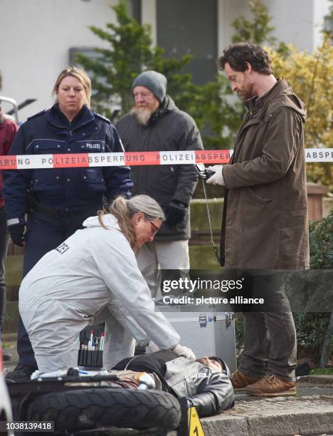 Actors Sybille J. Schedwill as coroner Greta Leitner and Joerg Hartmann as inspector Peter Faber stand next to the body of a rockers who was hit by...