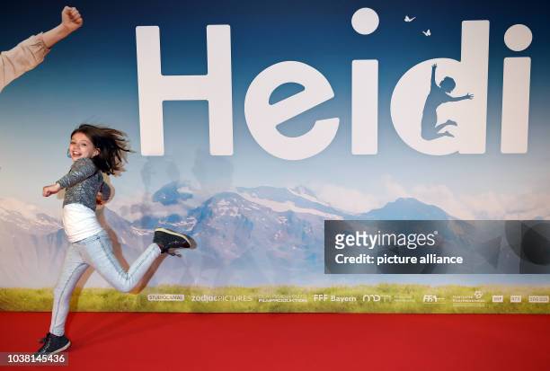 Actress Anuk Steffen runs across the red carpet during the German premiere of 'Heidi' in the Mathaeser Kino in Munich, Germany, 29 November 2015....