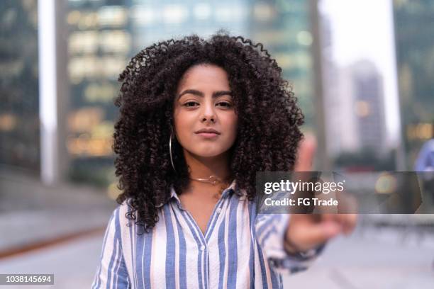 confident businesswoman gesturing number 1 - in the center stock pictures, royalty-free photos & images