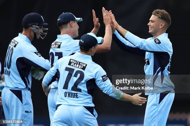 Chris Green of NSW celebrates with his team mates after taking the wicket of Peter Handscomb of Victoria during the JLT One Day Cup match between New...