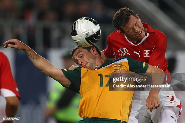 Scott McDonald of Australia battles for the ball with Stephan Lichtsteiner of Switzerland during an International friendly match between Switzerland...