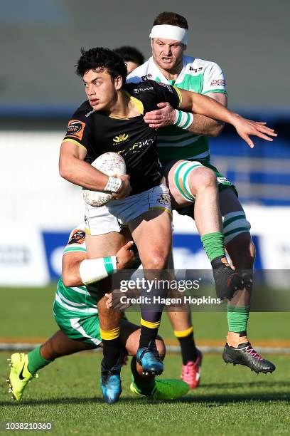 Thomas Umaga-Jensen of Wellington is tackled by Brad Tucker of Manawatu during the round six Mitre 10 Cup match between Manawatu and Wellington at...