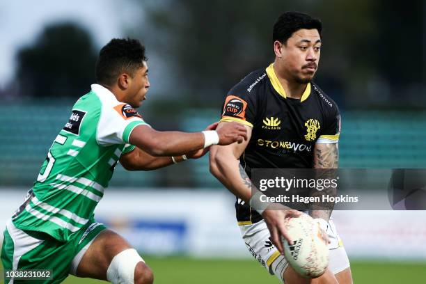 Ben Lam of Wellington looks to pass under pressure from Te Rangatira Waitoka of Manawatu during the round six Mitre 10 Cup match between Manawatu and...