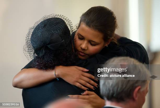 Almaz Boehm , the widow of Karlheinz Boehm and her daughter Aida hug each other at the memorial service of their father and husband Karlheinz Boehm...