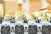 Rows of dedicated ASIC for cryptocurrency mining farm. Bitcoin, Ethereum and other altcoins producing rig.