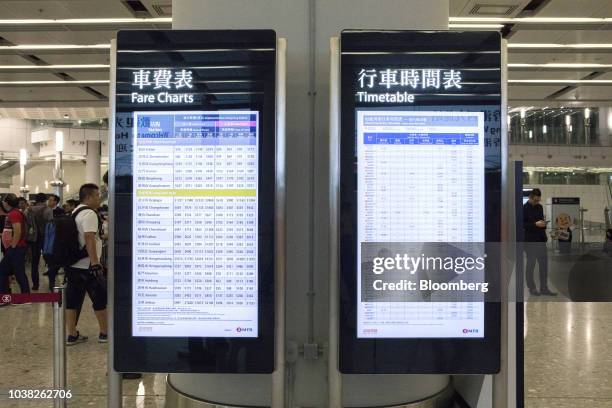 Fare charts and a train departure schedule stand inside West Kowloon Station, which houses the terminal for the Guangzhou-Shenzhen-Hong Kong Express...