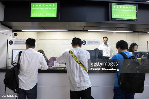 People stand at ticket counters inside West Kowloon Station, which houses the terminal for the Guangzhou-Shenzhen-Hong Kong Express Rail Link ,...