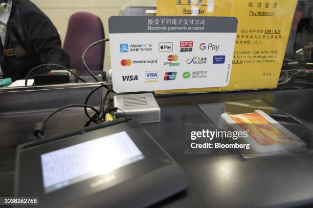 Sign displaying acceptable electronic payment methods is seen at a ticket counter inside West Kowloon Station, which houses the terminal for the...