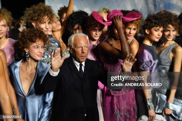 Italian fashion designer Giorgio Armani and models acknowledge applause following the presentation of the Armani fashion show, as part of the Women's...