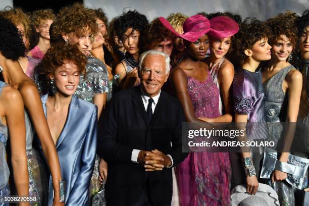 Italian fashion designer Giorgio Armani and models acknowledge applause following the presentation of the Armani fashion show, as part of the Women's...