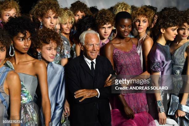 Italian fashion designer Giorgio Armani and models acknowledge applause following the presentation of the Armani fashion show, as part of the Women's...