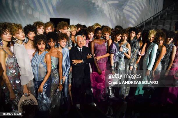 Italian fashion designer Giorgio Armani and models acknowledge applause following the presentation of the Armani fashion show, as part of the Women's...